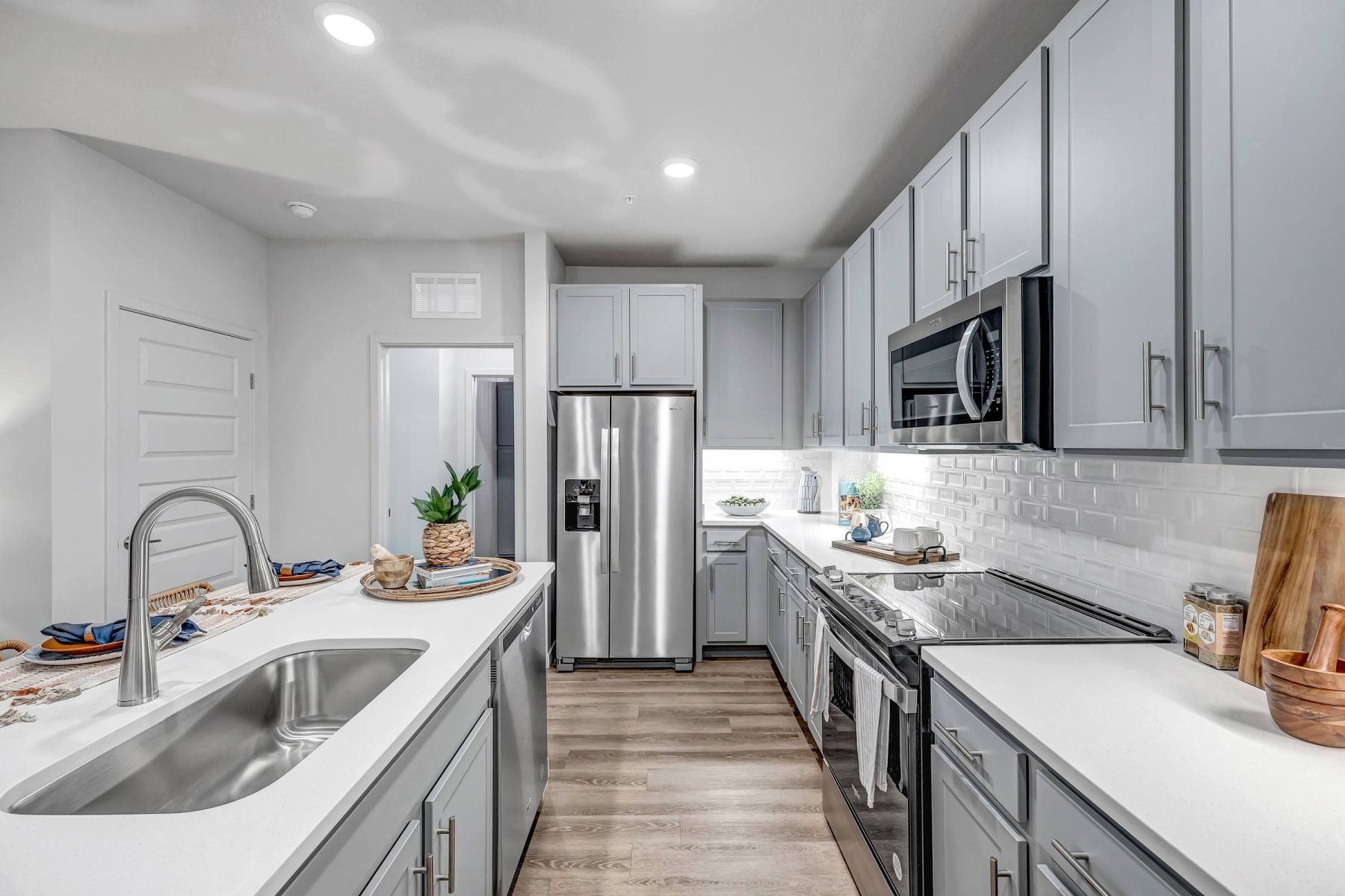 Luxury apartment kitchen with stainless steel appliances, granite countertops, and lots of storage space
